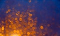 Blurred background with bokeh orange lights on dark blue background Royalty Free Stock Photo