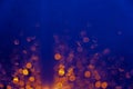 Blurred background with bokeh orange lights on dark blue background Royalty Free Stock Photo