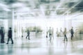 Blurred background of business people and activities inside an office building. The image captures the fast-paced and busy