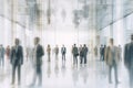 Blurred background of business people and activities inside an office building. The image captures the fast-paced and busy