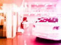 Blurred background with car dealership store interior. Blurred abstract dealership store with defocused cars. Blur bokeh Royalty Free Stock Photo