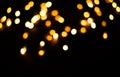 Blurred background. Christmas lights on a black background. Yellow light bulbs Royalty Free Stock Photo