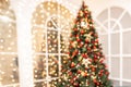 Blurred background Christmas room interior with New Year tree and gifts lights in red, green colors