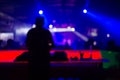 Blurred background : Club, disco DJ playing and mixing music for crowd of happy people. Nightlife, concert lights