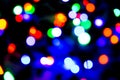 Blurred background with colorful bokeh lights on dark purple and blue background/blurred Christmas lights Royalty Free Stock Photo