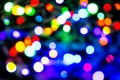 Blurred background with colorful bokeh lights on dark purple and blue background/blurred Christmas lights Royalty Free Stock Photo
