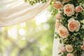 A blurred background complements a square wedding arch adorned with roses