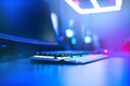 Blurred background computer, keyboard, blue and red lights. Concept eSports arena for gamer playing tournaments