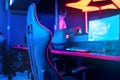 Blurred background computer pc, keyboard armchair, blue and red lights. Concept online eSports arena for gamer playing Royalty Free Stock Photo