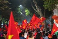 Blurred background of crowd of Vietnamese football fans down the street to celebrate the win after soccer, with a lot of Vietnames