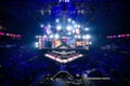 Blurred background of an esports event - Big illuminated main stage of a computer games tournament located on a big