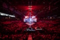 Blurred background of an esports event - Big illuminated main stage of a computer games tournament located on a big