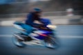 Blurred background with fast running motorcyclist