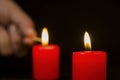 Blurred in the background a hand lighting candles Royalty Free Stock Photo