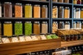 Blurred background of interior in zero waste shop. Customers buying dry goods and bulk products in plastic free grocery store.