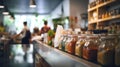 Blurred background of interior in zero waste shop. Customers buying dry goods and bulk products in plastic free grocery store.