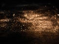 Blurred background lights. Abstract defocused gold, white, red and yellow glitters texture on black background. Shining glowing sn Royalty Free Stock Photo