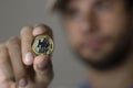 Man holding coin with blurred background