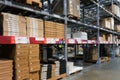 Many items inside cardboard boxes on warehouse storage shelves Royalty Free Stock Photo