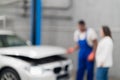 Blurred background of Mechanic and client inspect engine of car. Royalty Free Stock Photo