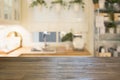 Blurred background. Modern defocused pastel kitchen with wooden tabletop and space for you.