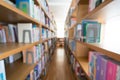 Blurred background of public library, bookshelf with books, diminishing perspective, education concept Royalty Free Stock Photo