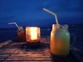 Blurred background, refreshing juices and candle light from cafe on the beach Royalty Free Stock Photo