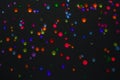 Blurred background. Top view on the multi-colored colorful rhinestones scattered on a black background. Abstraction Royalty Free Stock Photo
