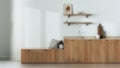 Blurred background, trendy cozy kitchen. Wooden cabinets, shelves and bench. Concrete floor, japandi interior design