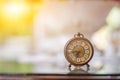 The blurred background of a vintage-style clock resting on the back of a piano in the music practice room is a collection of alarm