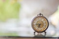 The blurred background of a vintage-style clock resting on the back of a piano in the music practice room is a collection of alarm