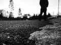 Blurred background. Walk in urban city. Close up view on man`s legs, car headlights Royalty Free Stock Photo