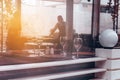 Blurred background window of the restaurant with wine glasse and waitress