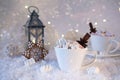 Blurred background of winter frost and Christmas chocolate spice beverage with cookies in cups