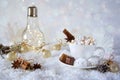 Blurred background of winter frost and Christmas chocolate spice beverage with sweets in cups