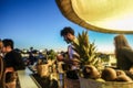 Blurred barman working in chiringuito bar at sunset beach party - Concept of nightlife with cocktails and music entertainment in Royalty Free Stock Photo