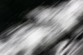 Blurred black & white image of moving water in sunlight
