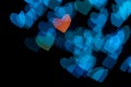 Blurred blue heart shapes bokeh on black backgrount. Valentines day concept