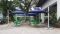 Blurred blue umbrellas and lounge chairs are located outside the building.In a shady atmosphere side the golf club Royalty Free Stock Photo