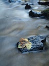 Blurred blue waves of stream running over gravel and stones Royalty Free Stock Photo