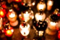 Blurred bokeh background of candle snitches on the tombstone, All Saints& x27; Day, the feast of the dead by night Royalty Free Stock Photo