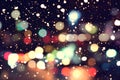 Blurred bokeh background of colorful christmas lights with snow fall Royalty Free Stock Photo