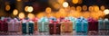 Blurred bokeh background of retail store window with vibrant stack of colorful gift boxes. Royalty Free Stock Photo