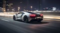 Blurred bokeh effect of city lights behind sleek sports car speeding down night highway
