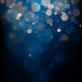 Blurred bokeh light on dark blue background. Christmas and New Year holidays template. Abstract glitter defocused