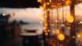 blurred bokeh light on sunset with yellow string lights decor in beach restaurant Royalty Free Stock Photo