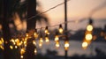 blurred bokeh light on sunset with yellow string lights decor in beach restaurant Royalty Free Stock Photo
