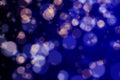 Blurred bokeh lights on dark blue background, abstract shiny blurry stars- concept of christmas and new year holidays Royalty Free Stock Photo