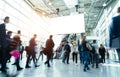 Blurred business people at a trade fair hall Royalty Free Stock Photo