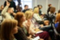 Blurred business seminar meeting in the conference hall. Defocused people